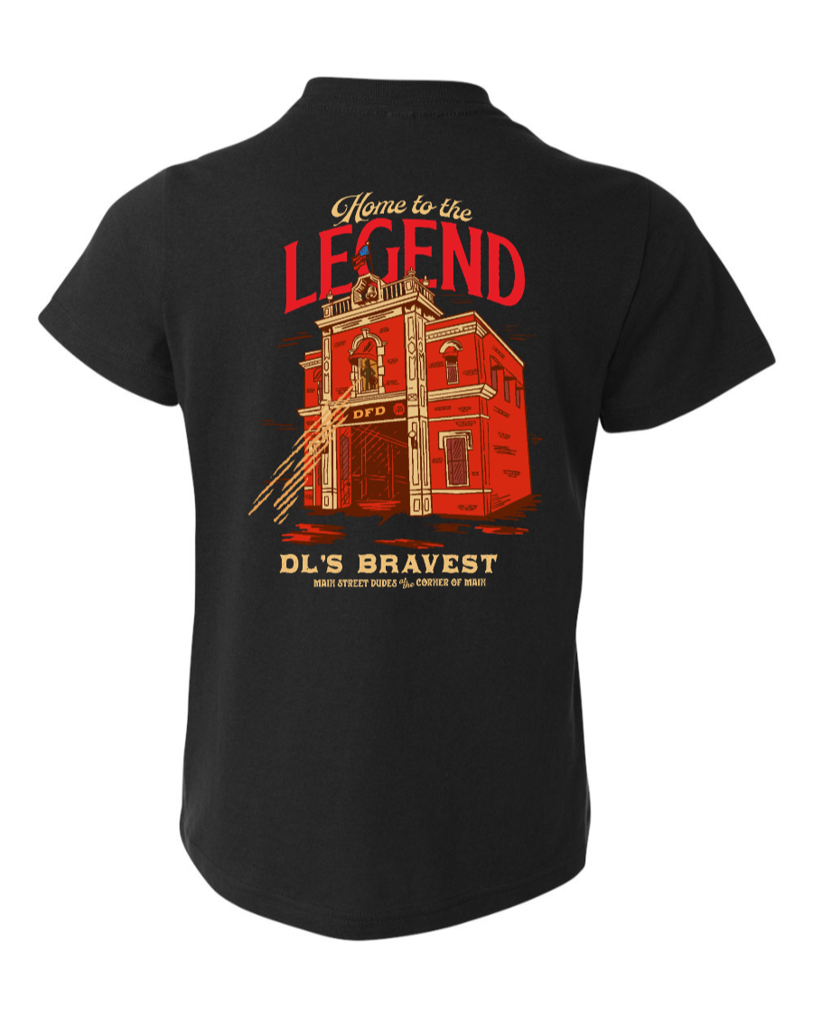 Black kids' T-shirt from Corner of Main featuring "Home to the Legend" graphic on the back.