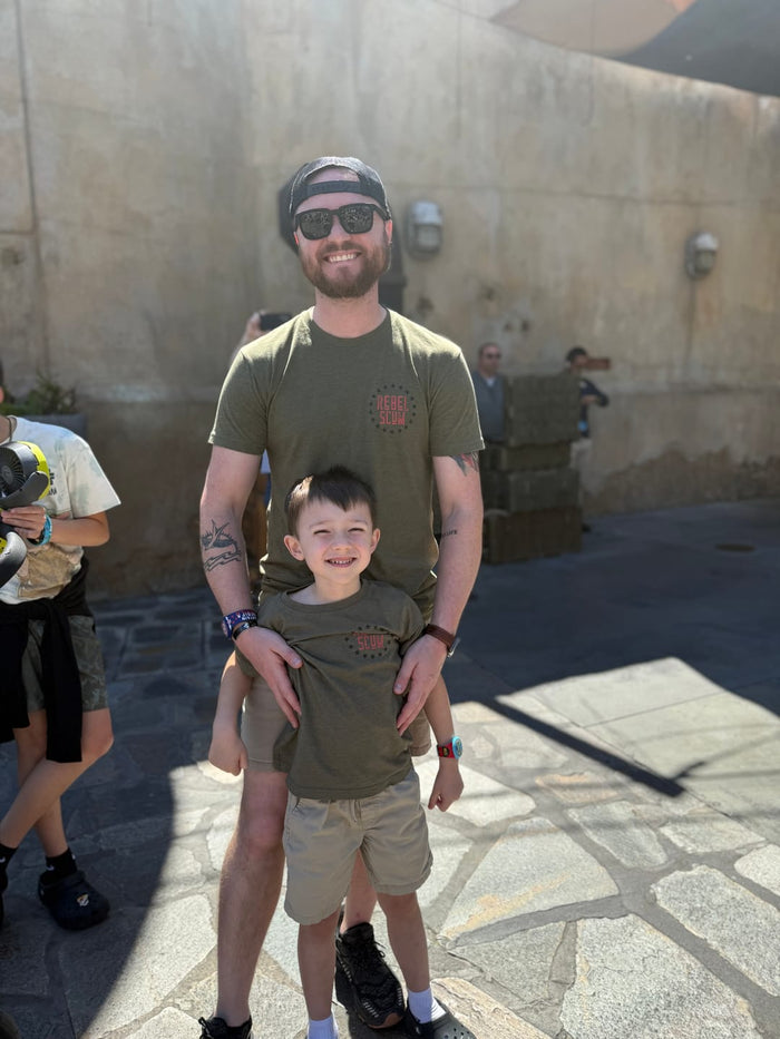 Dad and son wearing matching Rebel Scum tees