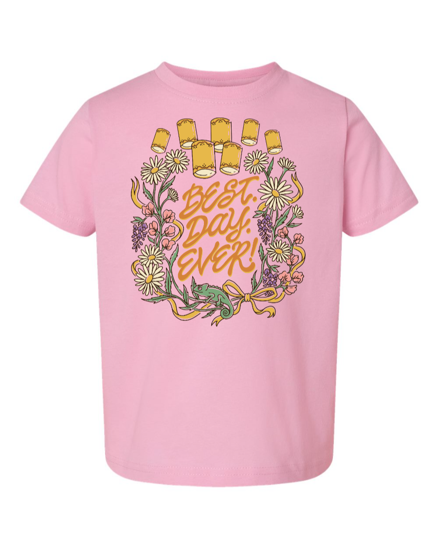 Pink toddler T-shirt by Corner of Main with "Best Day Ever" slogan, front view showing casual kids' shirt design.
