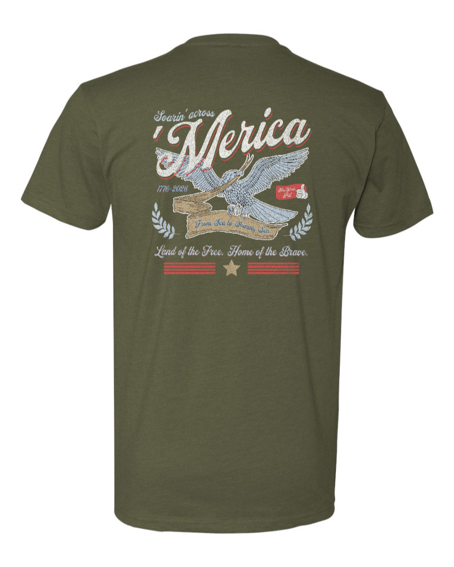 Military green Next Level T-shirt featuring "Soarin' Across 'Merica" graphic by Corner of Main, displayed on a plain background.