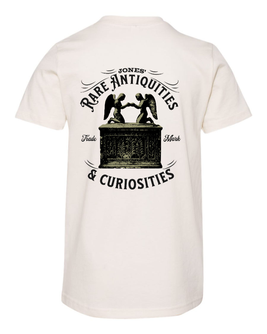 Corner of Main Jones Rare Antiquities youth T-shirt in natural color, showing back view with graphic design and comfortable fit.