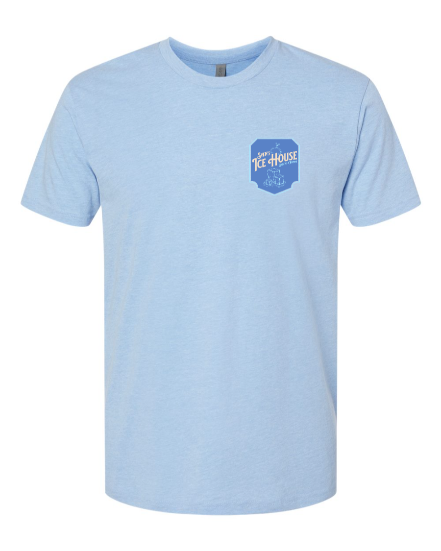Corner of Main Sven's Ice House Next Level T-Shirt in Heather Columbia Blue, featuring a left chest graphic.