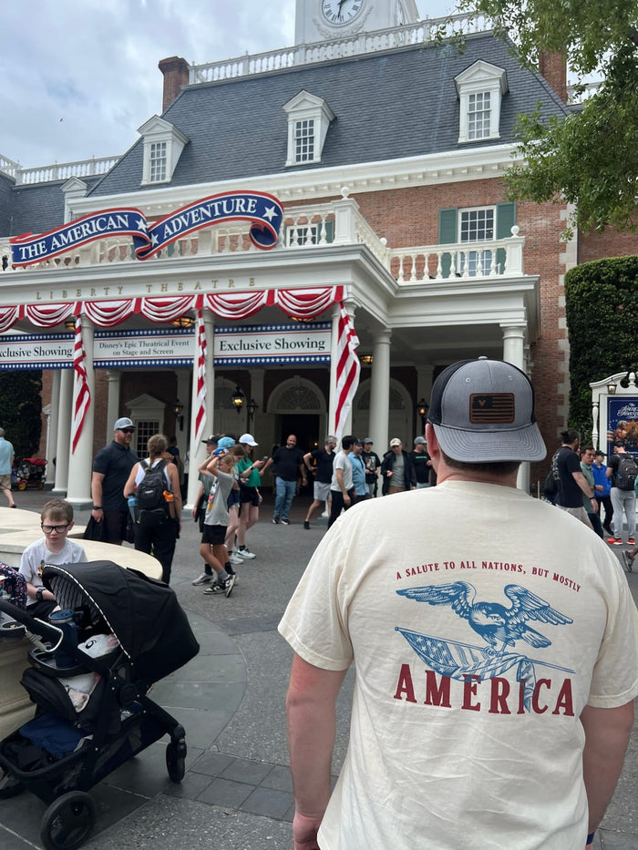 Customer wearing the A Salute to All Nations But Mostly America tee at EPCOT